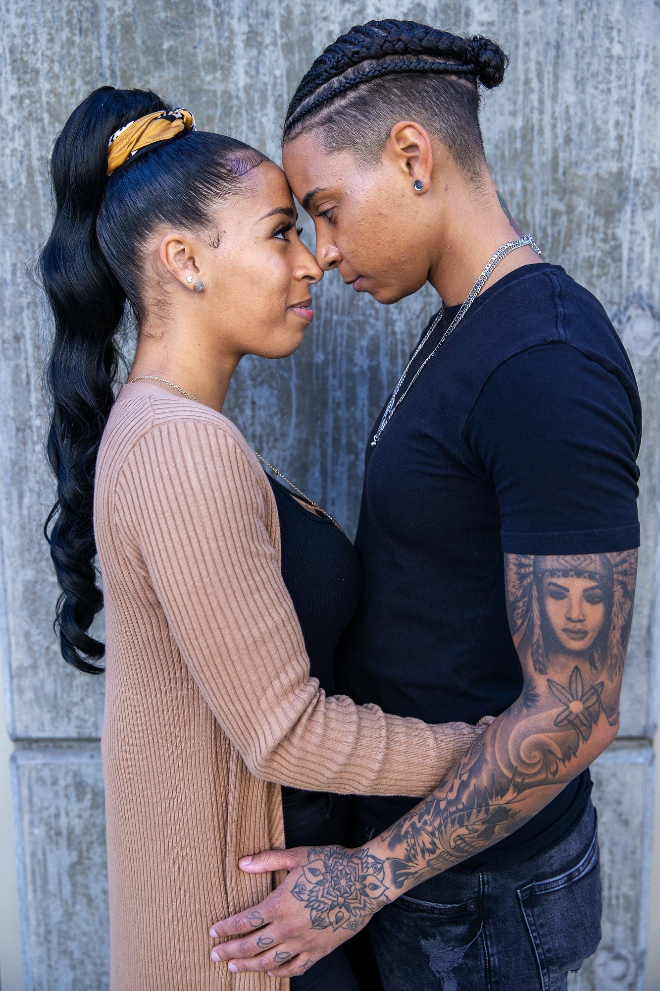 African American lesbian couple touching foreheads in tender moment together